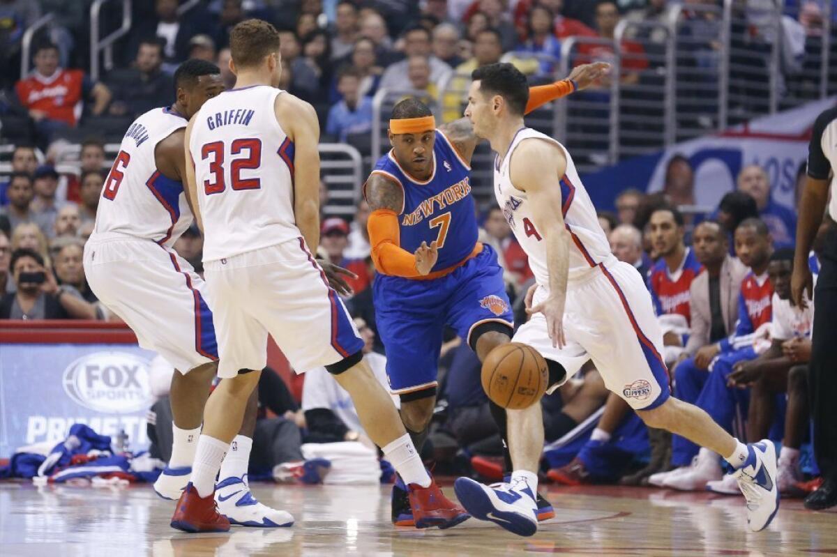J.J. Redick dribbles the ball as New York Knicks guard Carmelo Anthony defends him Nov. 27.