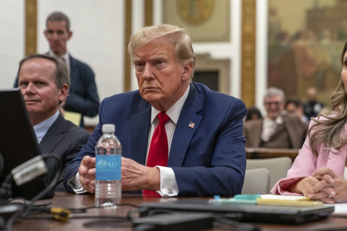 Former President Trump sits in court listening.
