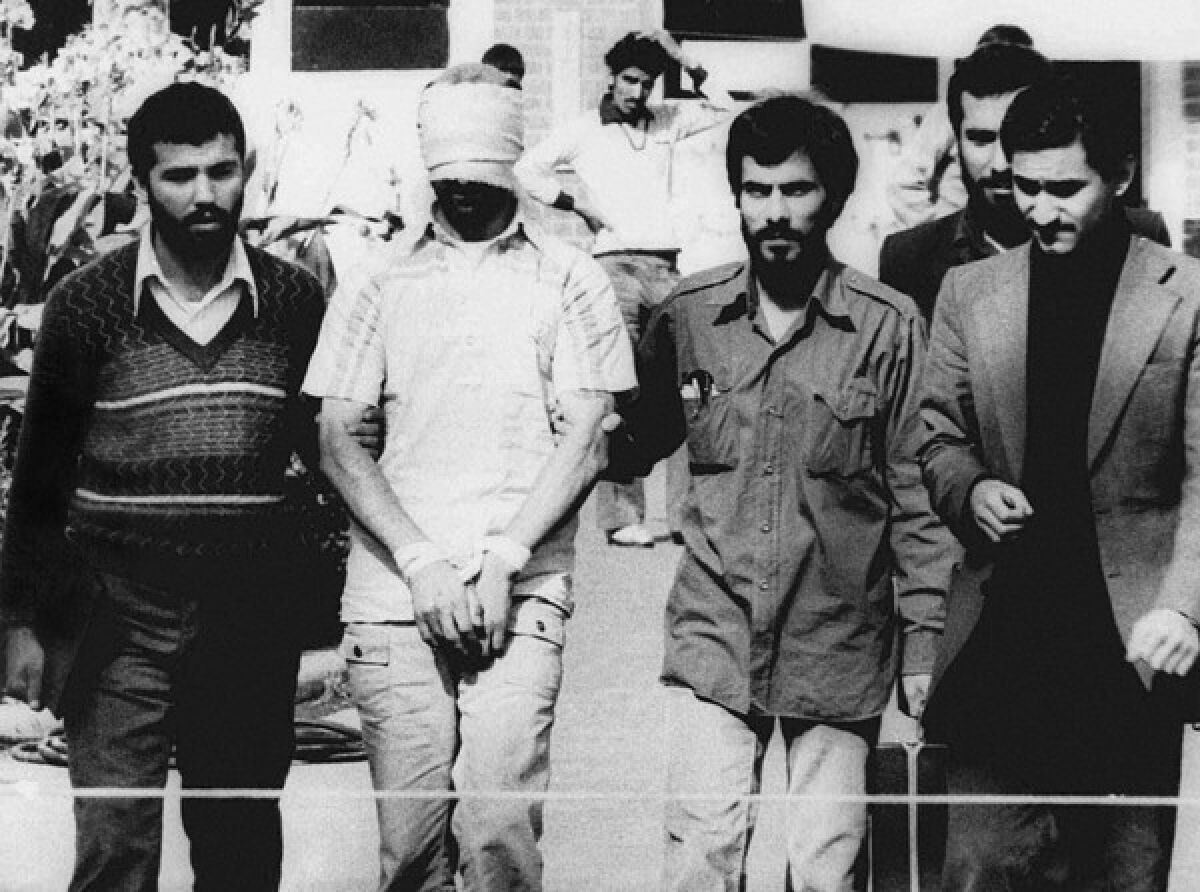 An American hostage, blindfolded and with his hands bound, was displayed to the crowd outside the U.S. Embassy in Tehran.