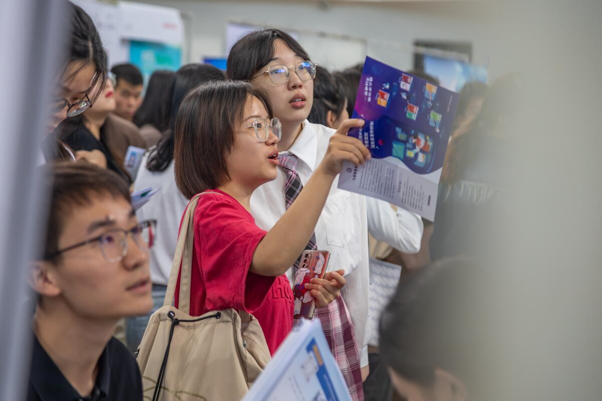 Students attend a job fair for graduates at Zhengzhou University in China.