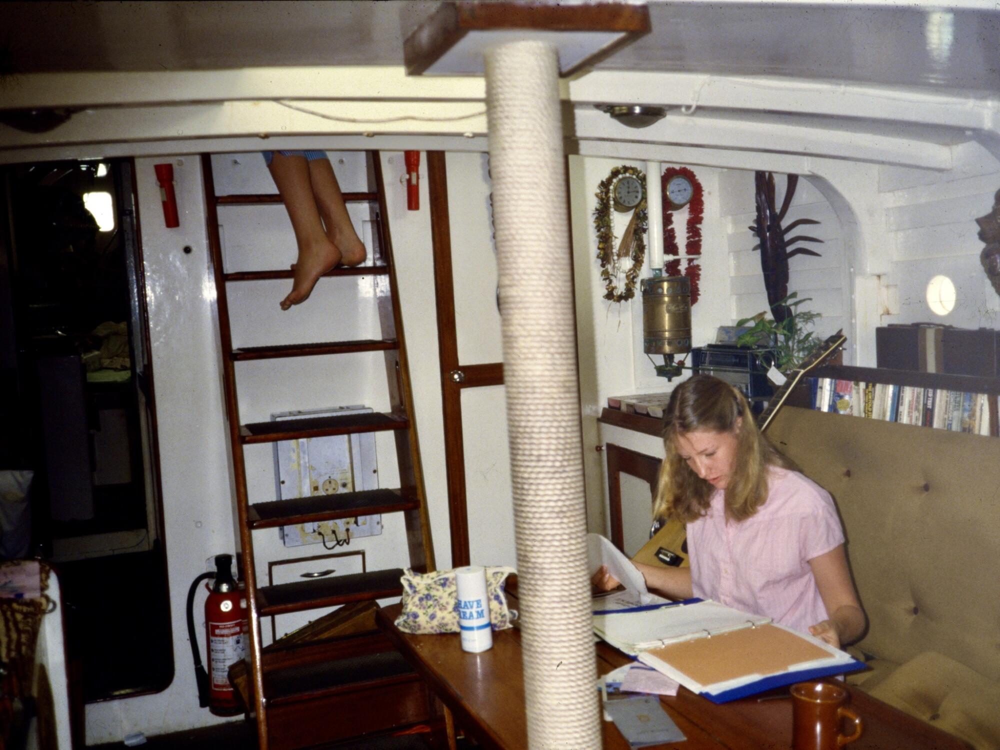 Heywood, probably 16, circa 1985, studying below deck. She eventually caught up on her education and graduated from Oxford.