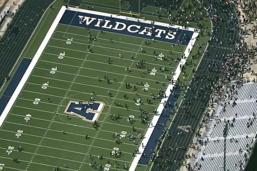 Students are evacuated to the football stadium after the school campus was placed on lockdown at Apalachee High School in Winder, Ga., on Wednesday, Sept. 4, 2024. (WSB via AP)