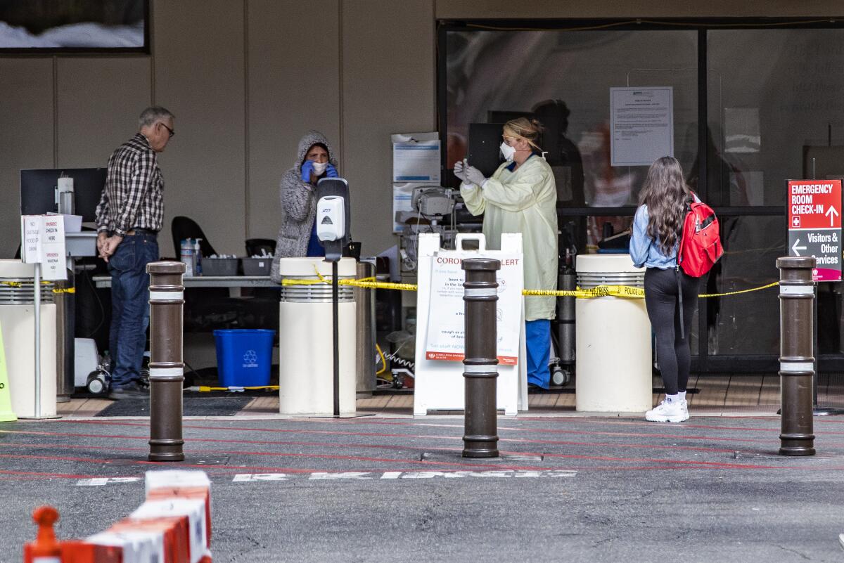 Medical personnel screen patients outside the emergency room at Loma Linda University Health last week.