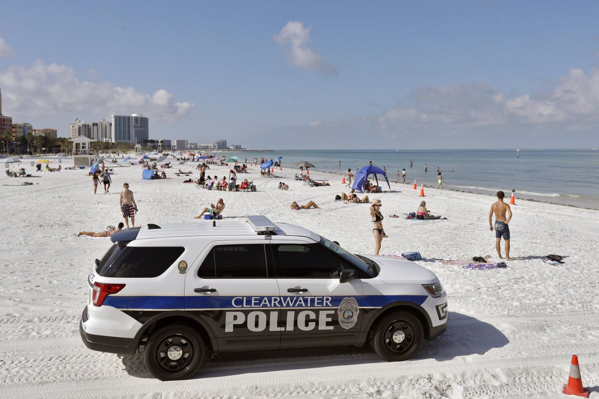 Police officers drive an SUV on the coast in Clearwater Beach . (AP Photo/, File)