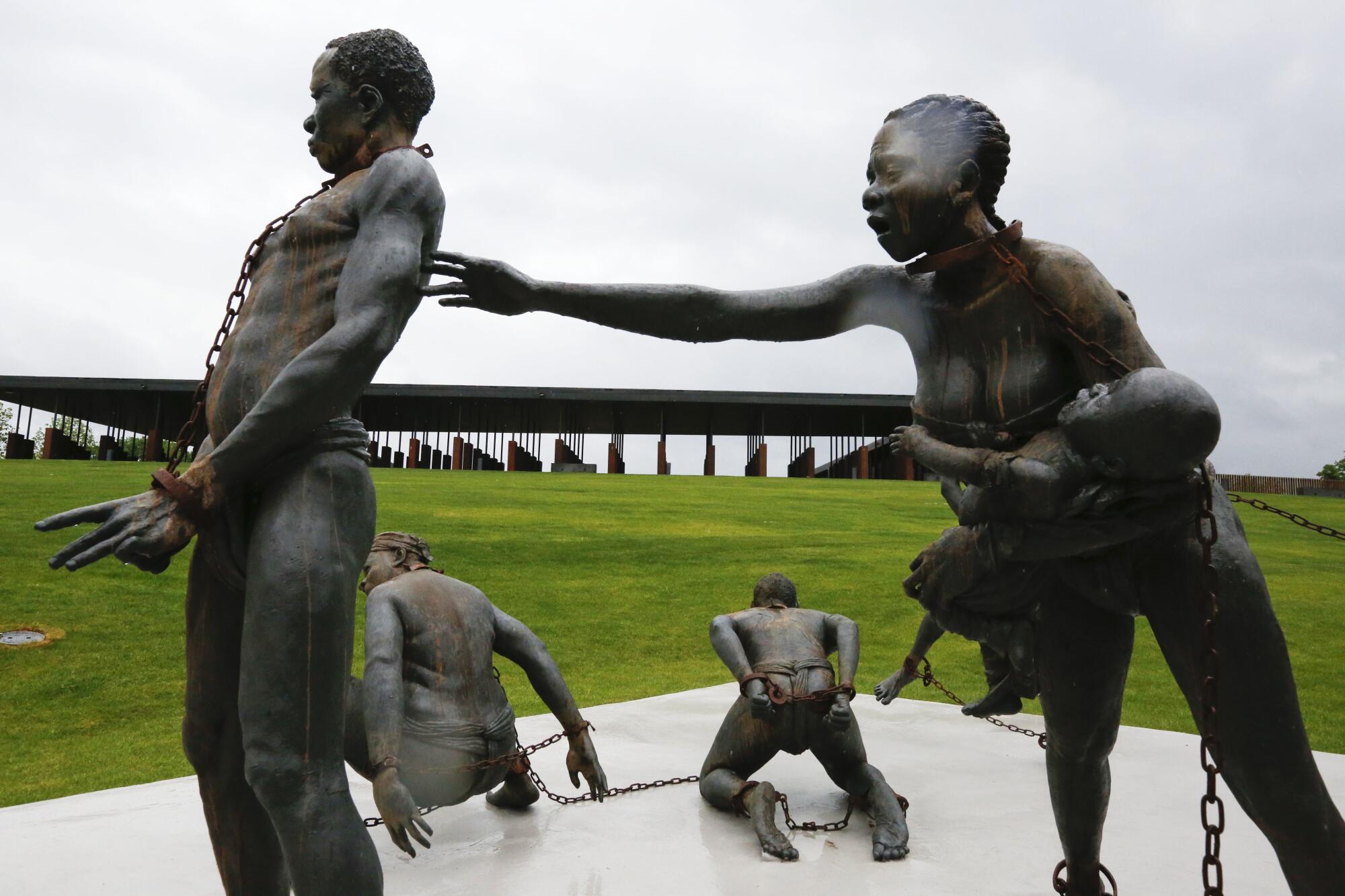 Statues of slaves chained together at the National Memorial for Peace and Justice in Montgomery, Ala.