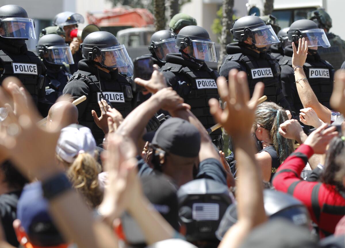 San Diego police in riot gear face protesters