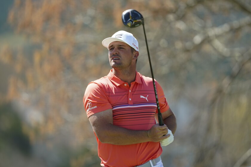 Bryson DeChambeau watches his shot from the sixth tee during the third round of the Dell Technologies Match Play Championship golf tournament, Friday, March 25, 2022, in Austin, Texas. (AP Photo/Tony Gutierrez)