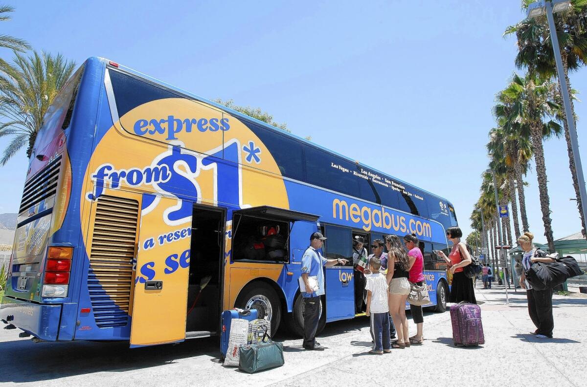 People wait to load up on the San Francisco-bound Megabus at the Burbank Metrolink station in burbank on Friday, July 11, 2014.