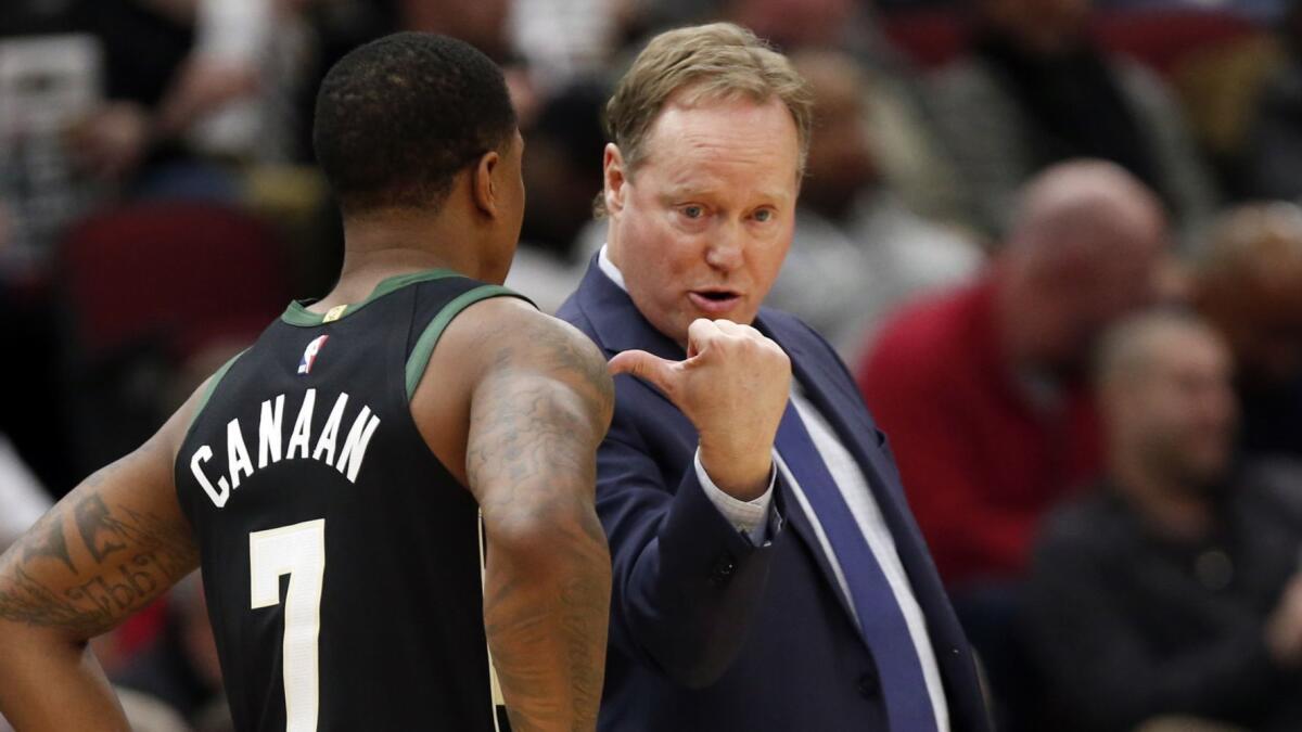 Bucks coach Mike Budenholzer speaks with reserve guard Isaiah Canaan during a game against the Chicago Bulls on Feb. 25, 2019.
