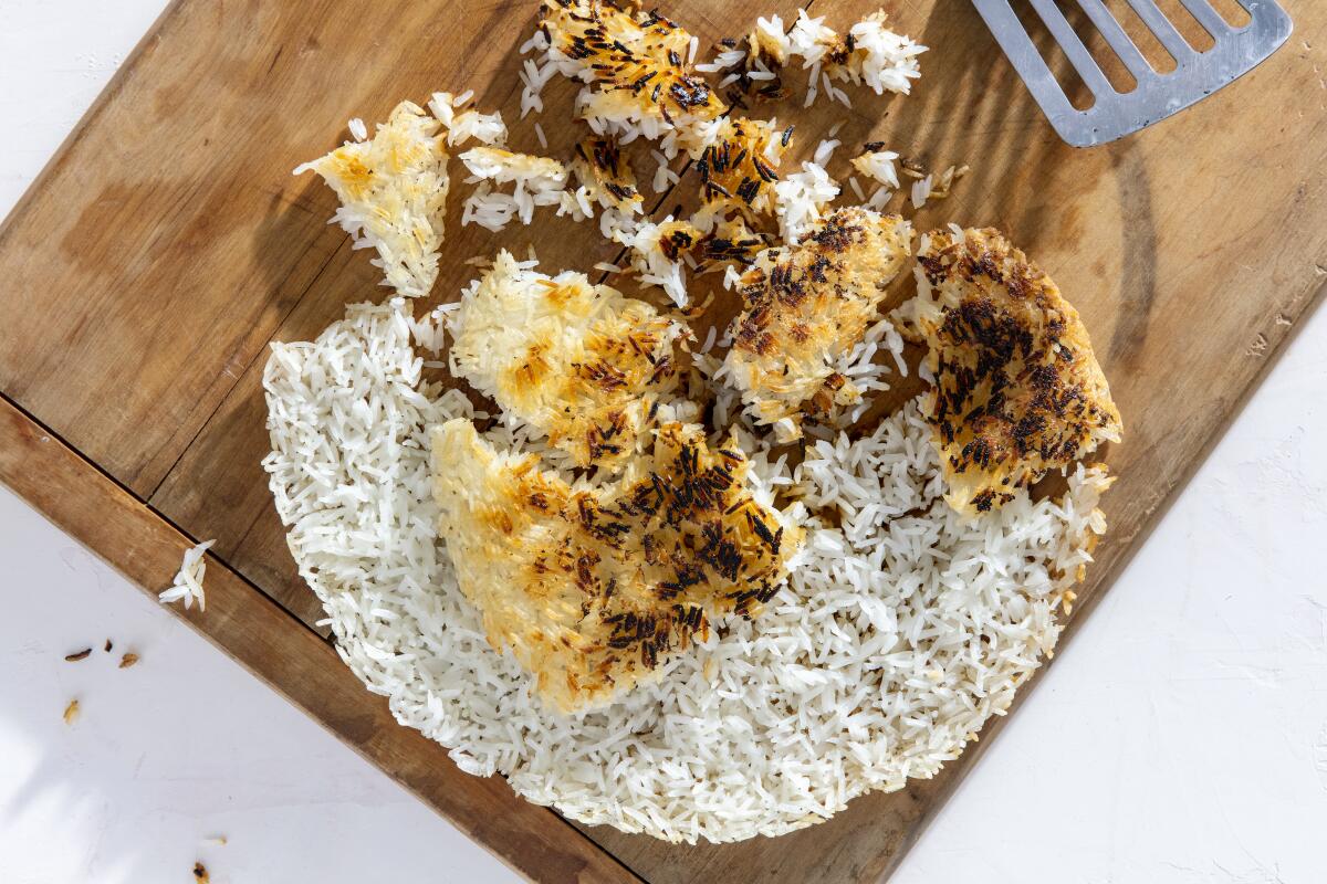 Basically the crispy bottom from a pot of Persian tahdig or Spanish paella, this thin crispy rice cake adds crunch and toastiness to a bright herb salad to serve with seared scallops. Prop styling by Rebecca Buenik.