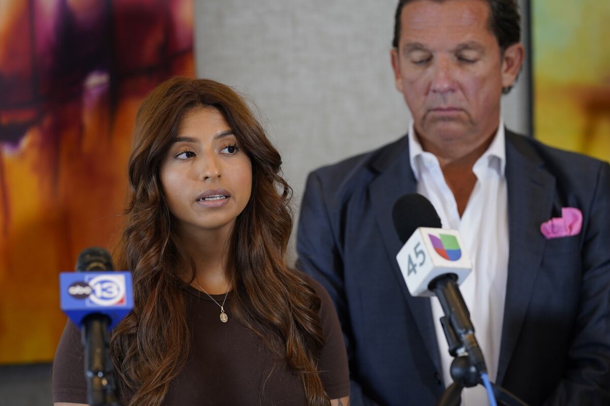 Ashley Solis, left, the first woman among several plaintiffs to file lawsuits accusing Cleveland Browns quarterback Deshaun Watson of sexual assault or harassment, speaks as her attorney Tony Buzbee stands beside her during a news conference to give an update to the lawsuits Thursday, Aug. 4, 2022, in Houston. The NFL is appealing a disciplinary officer's decision to suspend Watson for six games for violating the league's personal conduct policy. (AP Photo/David J. Phillip)