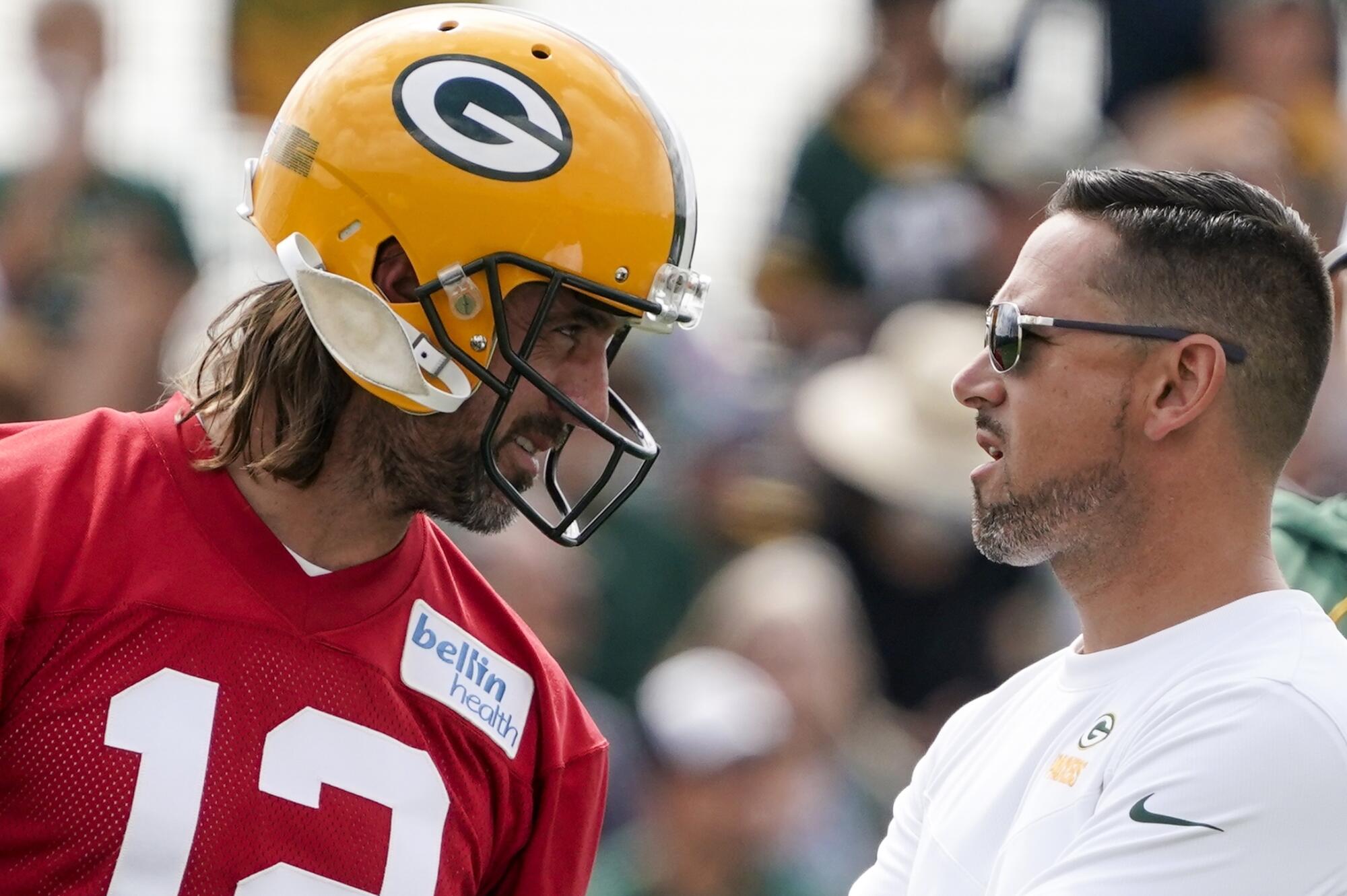 Green Bay Packers quarterback Aaron Rodgers talks to coach Matt LaFleur in training camp.