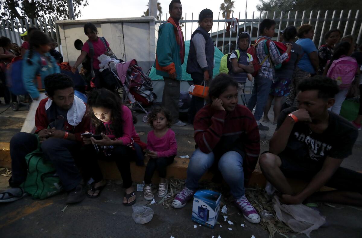 Hondurans, who were part of the migrant caravan, wait for shelter outside the Benito Juarez Sports Center in Tijuana.