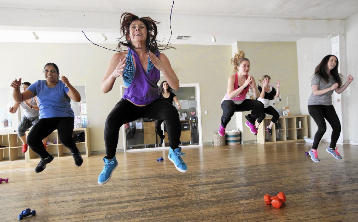 Instructor Shawnee Rioles, foreground, gets off the ground with students during a Zumba toning class at Heartbeat House in Atwater Village.