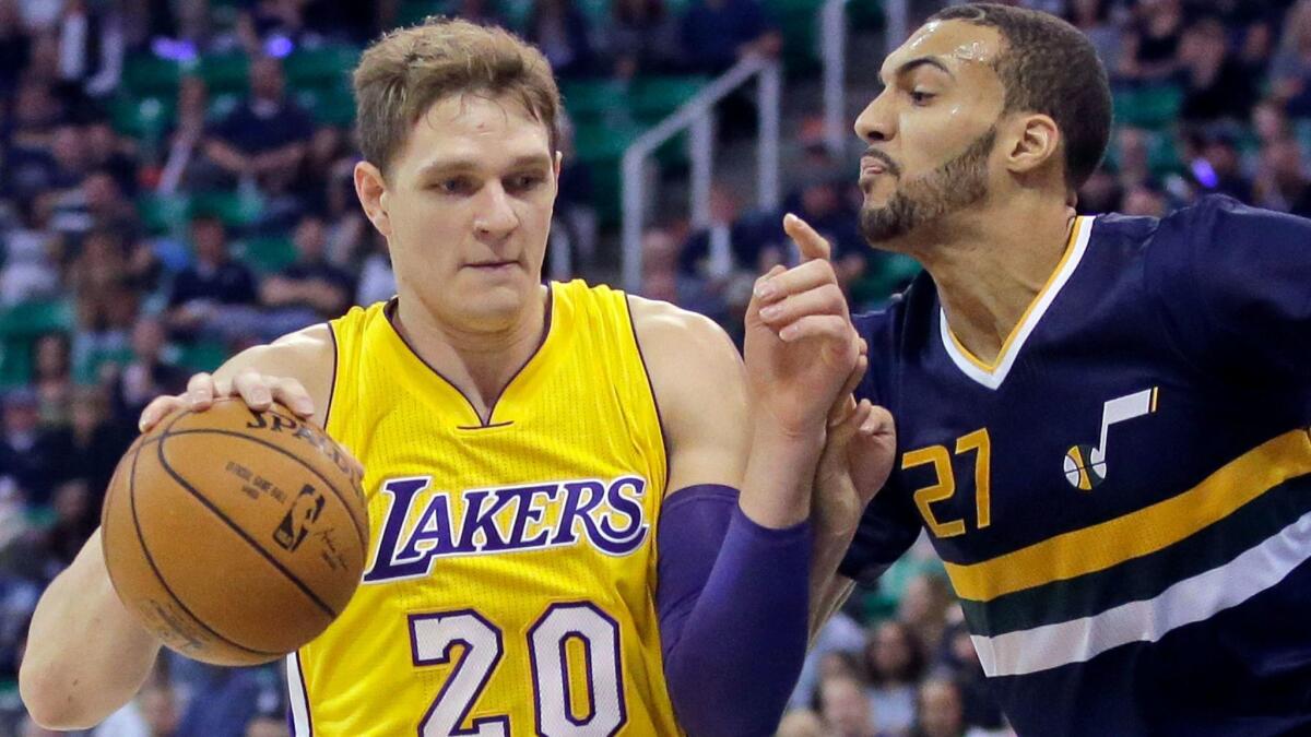 The Lakers' Timofey Mozgov tries to get past Utah's Rudy Gobert on Oct. 28.