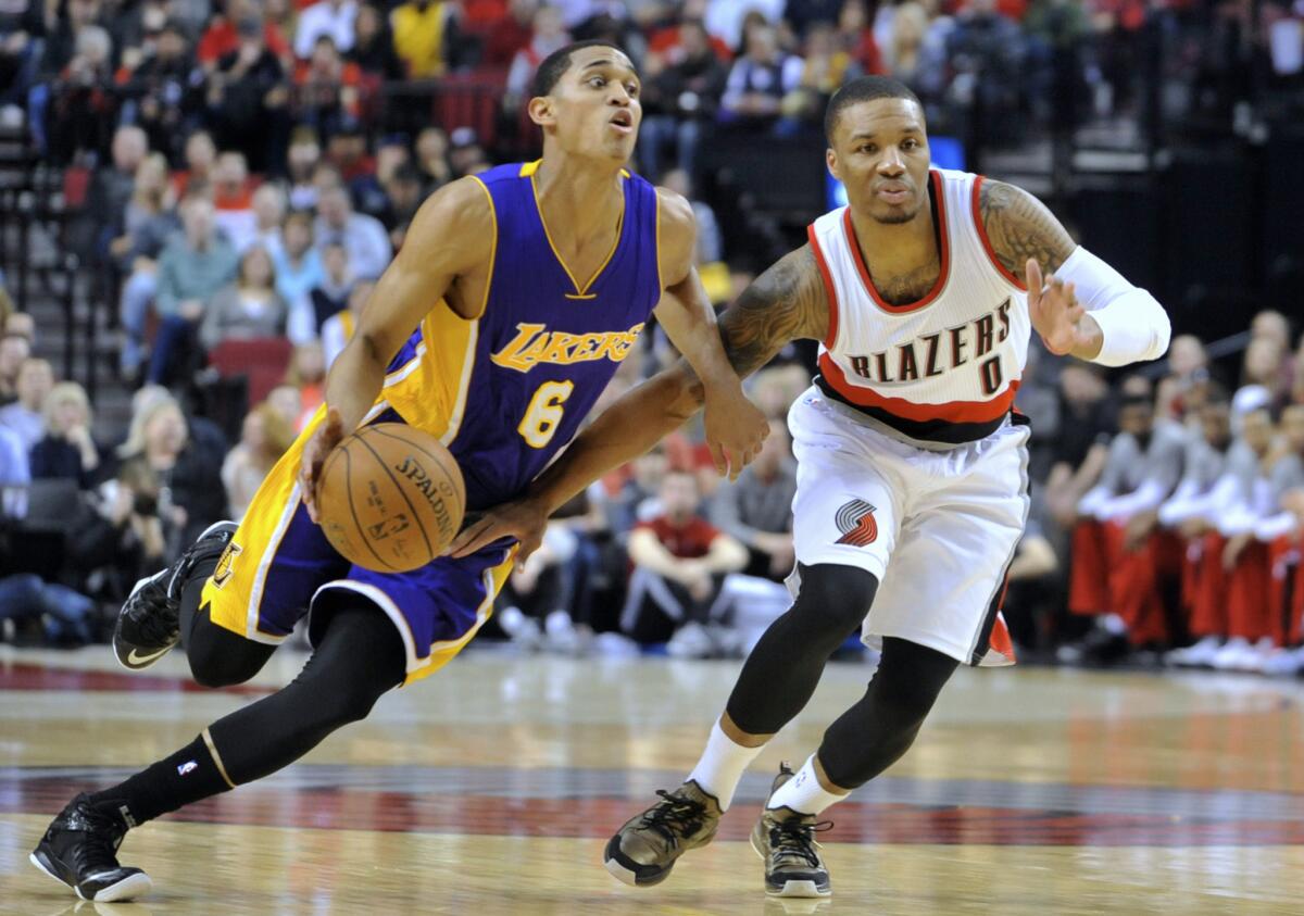 Jordan Clarkson drives to the hoop against Portland guard Damian Lillard during the first half of a game in February at Moda Center.