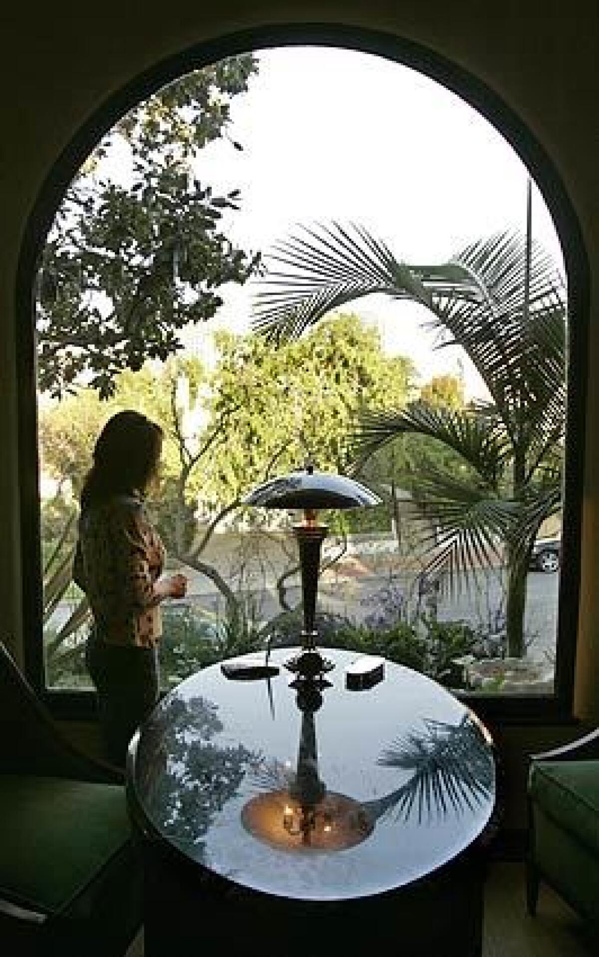Pamela Volante looks onto the diverse landscaping at her Westwood home. The interior designer says, Its a little English garden plus a little desert garden.