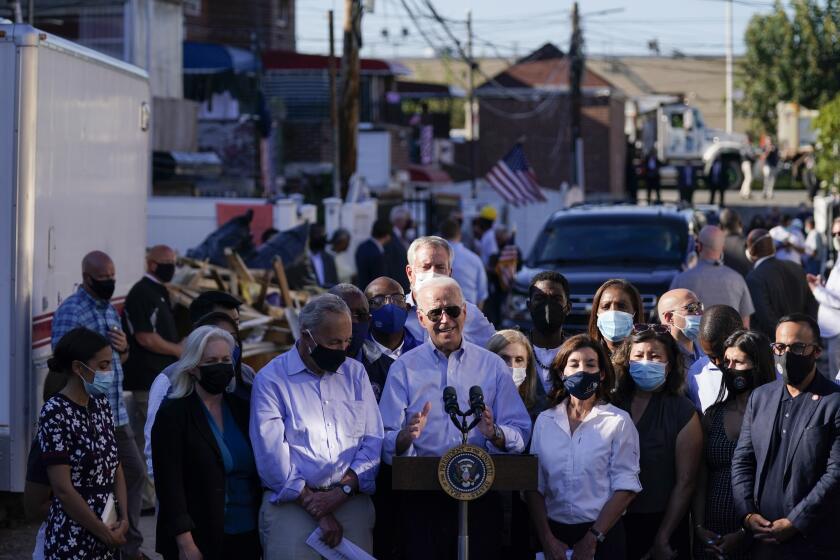 President Joe Biden speaks as he tours a neighborhood impacted by flooding from the remnants of Hurricane Ida, Tuesday, Sept. 7, 2021, in the Queens borough of New York. (AP Photo/Evan Vucci)