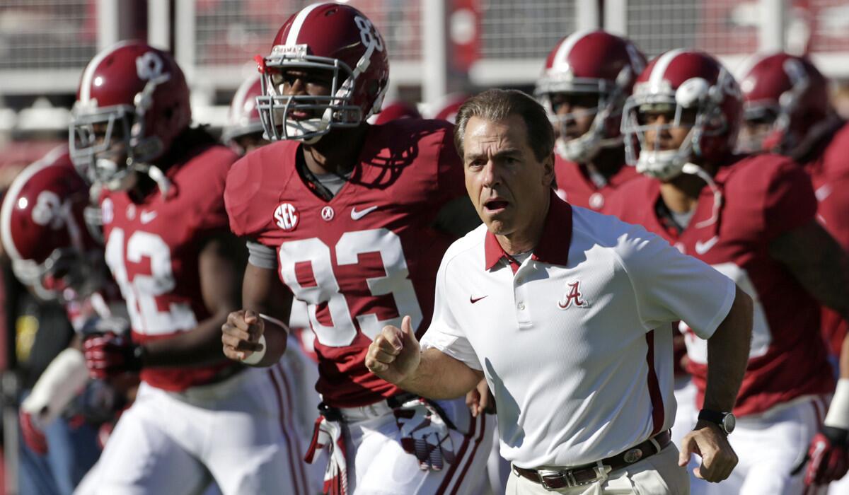 Alabama coach Nick Saban runs on to the field with his team prior to the start of a game against Texas A&M on Nov. 10, 2012.
