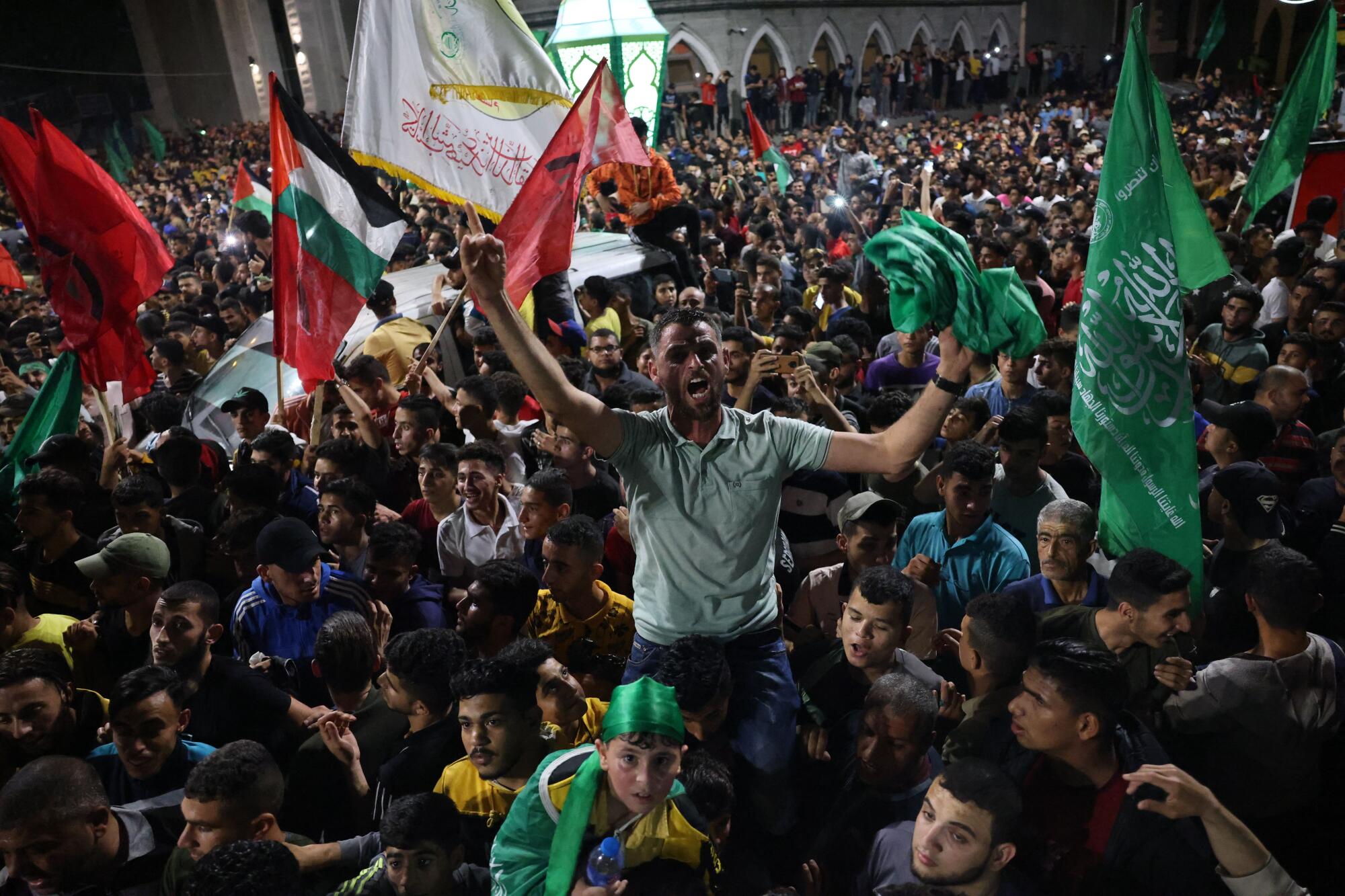 A man is hoisted on the shoulders of a celebrating crowd