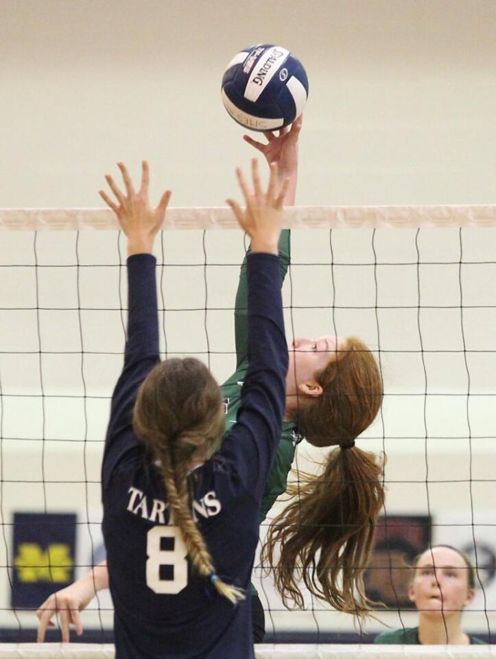 Sage Hill's Sydney Francis tips the ball over the hands of a St. Margaret's middle blocker.