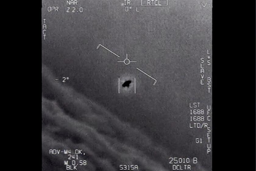 The image from video provided by the Department of Defense labelled Gimbal, from 2015, an unexplained object is seen at center as it is tracked as it soars high along the clouds, traveling against the wind. “There's a whole fleet of them,” one naval aviator tells another, though only one indistinct object is shown. “It's rotating." The U.S. government has been taking a hard look at unidentified flying objects, under orders from Congress, and a report summarizing what officials know is expected to come out in June 2021. (Department of Defense via AP)