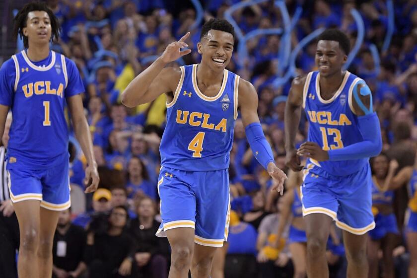 FILE - In this Feb. 28, 2019, file photo, UCLA guard Jaylen Hands, center, celebrates after hitting a 3-point shot as center Moses Brown, left, and guard Kris Wilkes follow during the second half of the teams' NCAA college basketball game against Southern California in Los Angeles. UCLA won 93-88 in overtime. . The Bruins sophomore guard has been one of the conferences best players all season and was named player of the week after finishing with 21 points and 10 assists in UCLAs win over rival USC. (AP Photo/Mark J. Terrill, File)