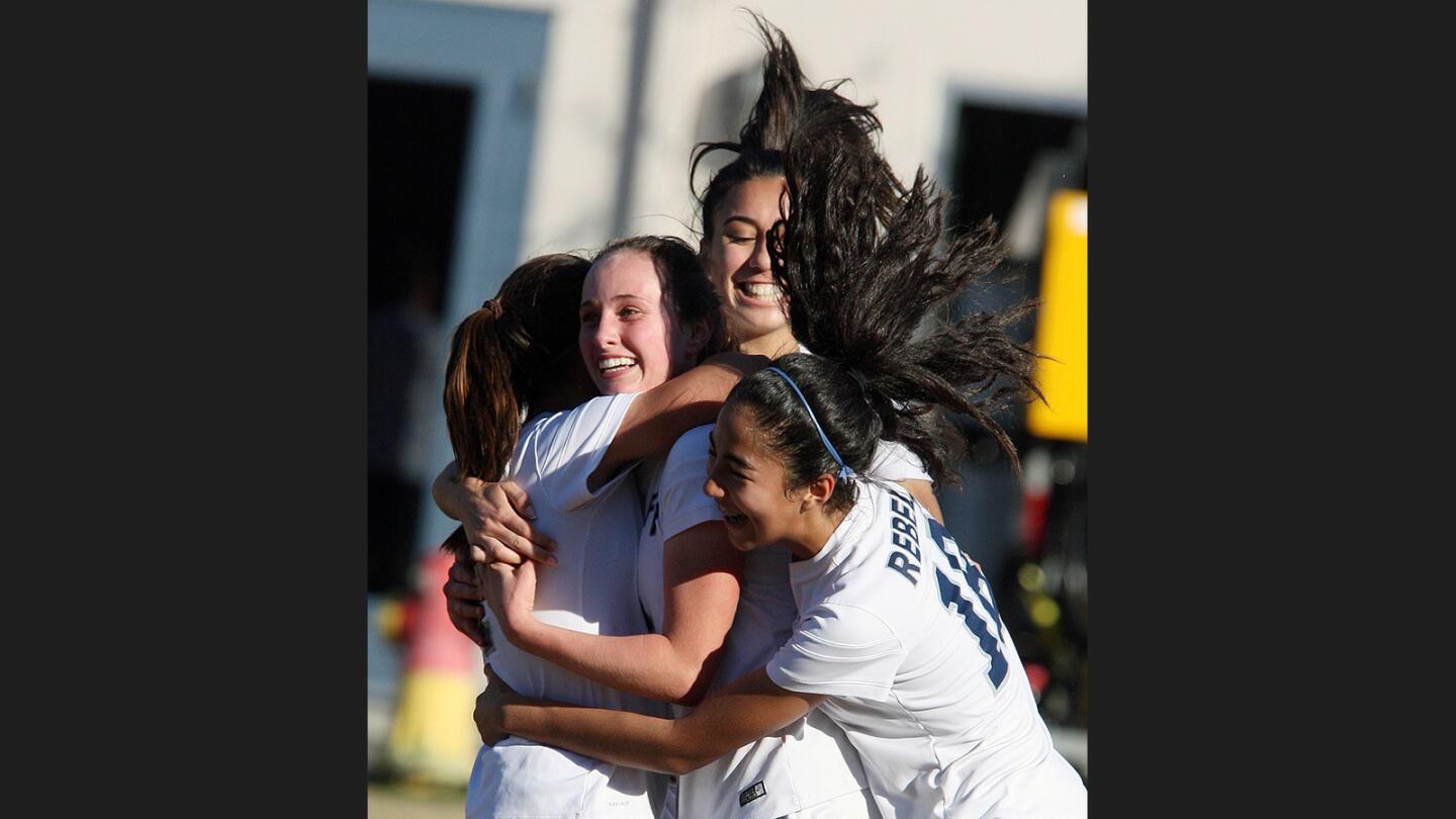 Flintridge Prep's Mikaela Celeste, middle, smiles as she is surrounded by teammates after scoring the second goal of the game against Oak Hills in a CIF Southern Section quarterfinal girls' soccer game at Flintridge Prep on Friday, February 24, 2017. Flintridge Prep won the game 3-0.