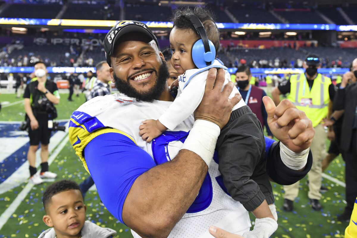 Rams defensive end Aaron Donald (99) celebrates with his family after winning Super Bowl LVI.