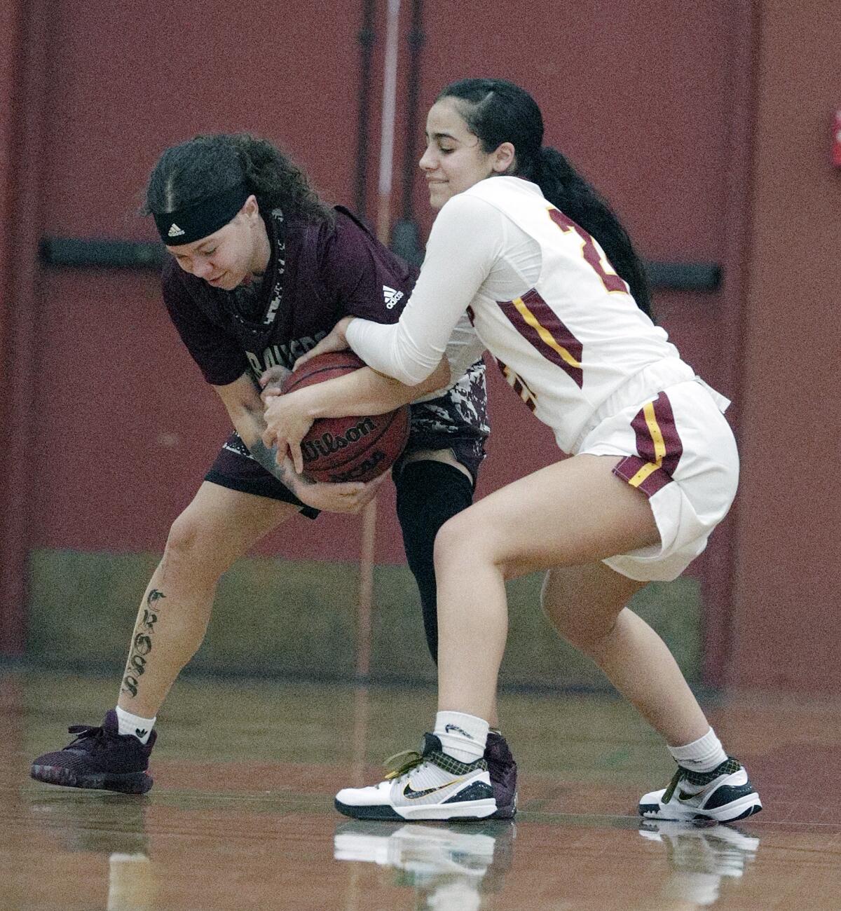 Antelope Valley's Kianna Cross and Glendale Community College's Zoe Rouse battle for a loose ball in a Western State Conference women's basketball game at Glendale Community College on Wednesday, January 22, 2020.