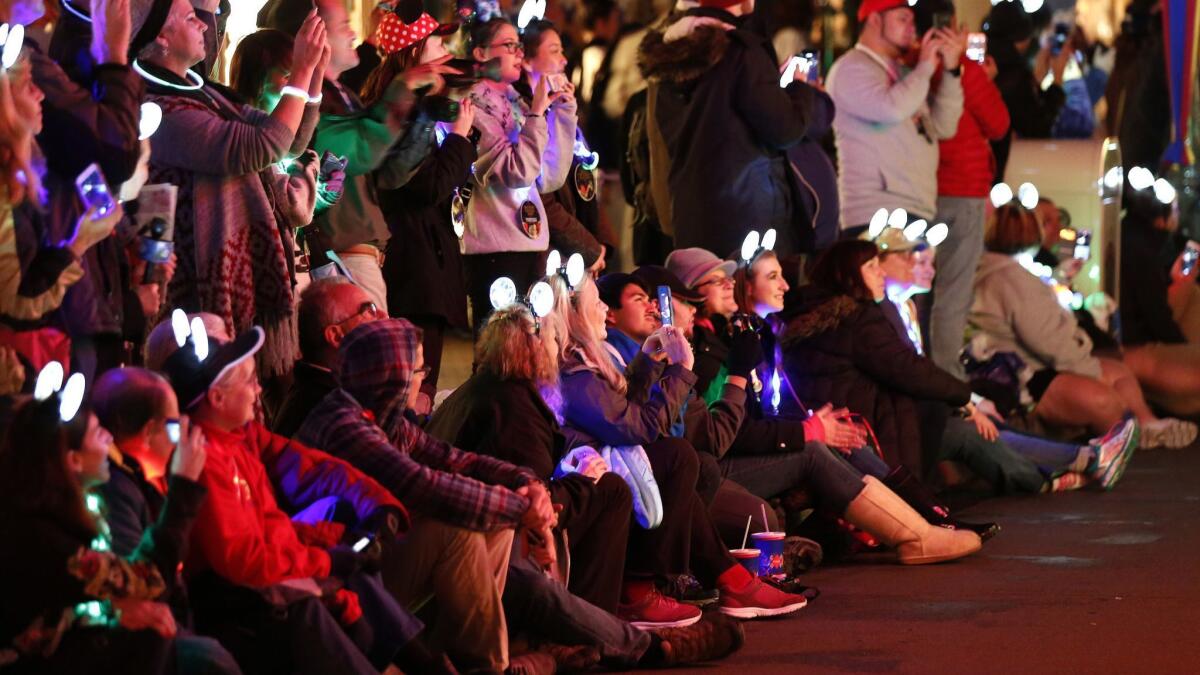 Fans shoot photos and videos of the Main Street Electrical Parade last year at Disneyland in Anaheim. The resort is adding hot spots throughout the park to make it easier for fans to connect to the internet.