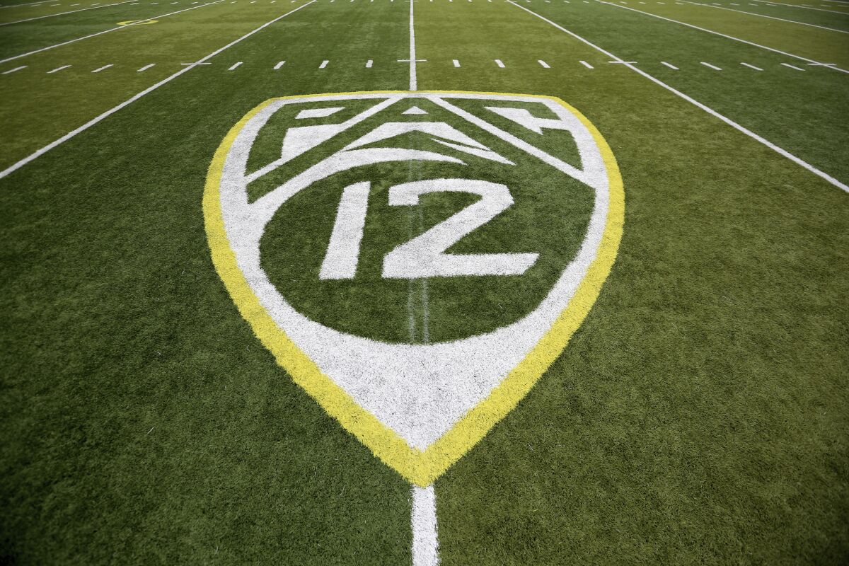 A Pac-12 logo is displayed on a football field. 