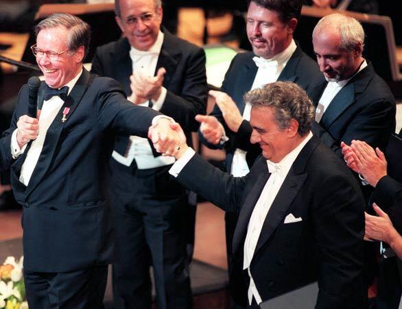 Peter Hemmings, left, acknowledged Placido Domingo during the Peter Hemmings Celebration Concert in 2000 at the Dorothy Chandler Pavillion. The gala concert was held to honor founding general director Peter Hemming's retirement from his service at the Los Angeles Opera.