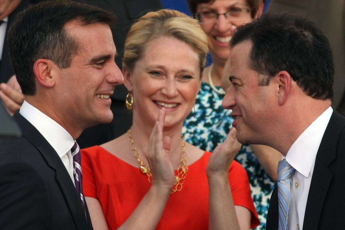 Late night television host Jimmy Kimmel, right, congratulates Mayor Eric Garcetti as Garcetti's wife Amy Wakeland looks on at City Hall in downtown Los Angeles on June 30, 2013.