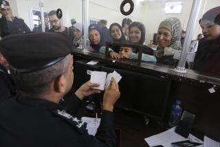 Palestinians with dual nationality register to cross to Egypt on the Gaza Strip side of the border crossing in Rafah on Thursday, Nov. 2, 2023. (AP Photo/Hatem Ali)