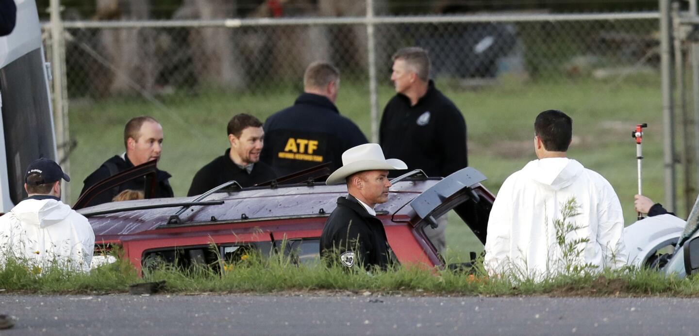 Officials investigate the scene where a suspect in a series of bombing attacks in Austin, Texas, blew himself up near Round Rock as authorities closed in.