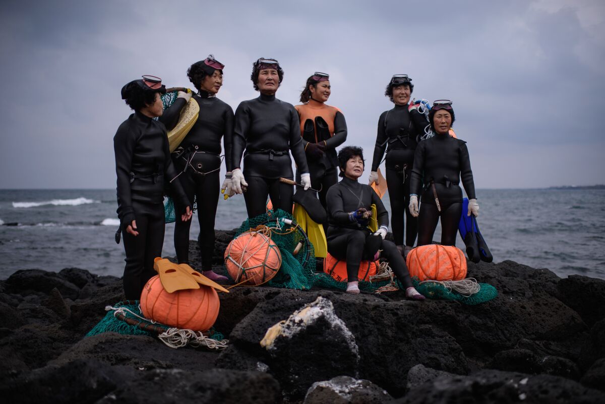 A group of haenyeo posed for photographers in 2015 as they performed a demonstration on the island of Jeju.