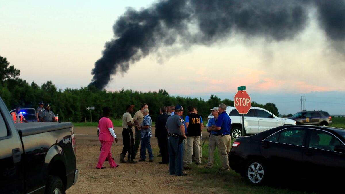 Emergency officials respond to the site of a military plane crash near Itta Bena, Miss., on Monday, July 10, 2017.