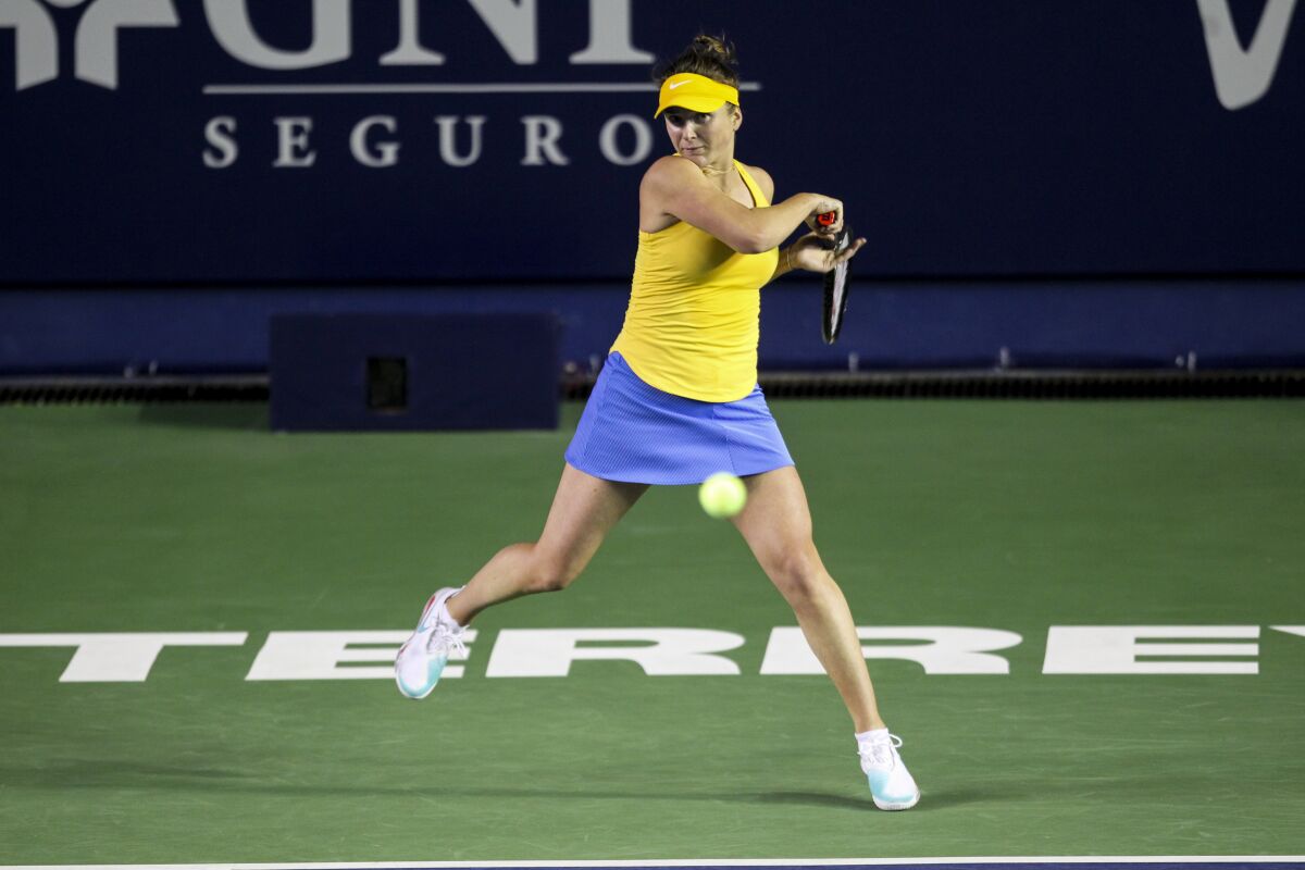 Elina Svitolina of Ukraine hits a return during a match against Anastasia Potapova of Russia.