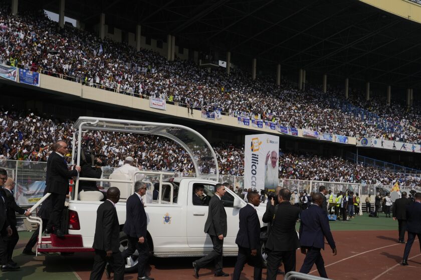 Pope Francis arrives on the popemobile at the Martyrs' Stadium in Kinshasa, Democratic Republic of Congo for a meeting with young people, Thursday, Feb. 2, 2023. Francis is in Congo and South Sudan for a six-day trip, hoping to bring comfort and encouragement to two countries that have been riven by poverty, conflicts and what he calls a "colonialist mentality" that has exploited Africa for centuries. (AP Photo/Gregorio Borgia)