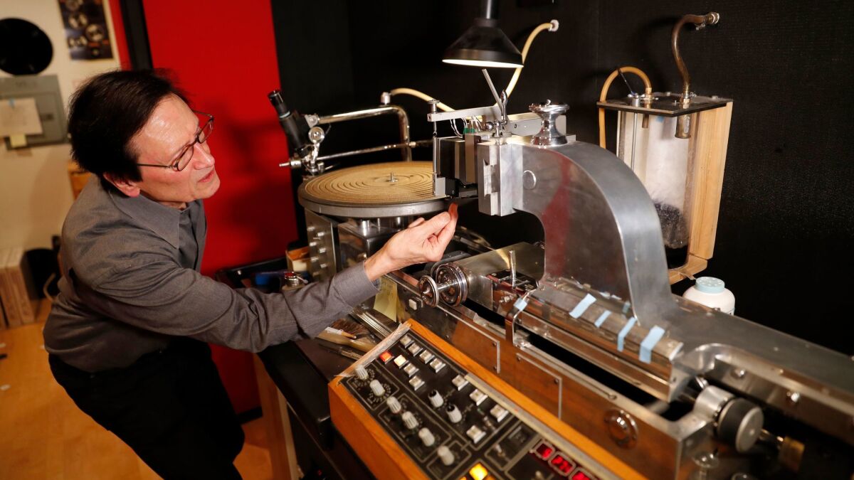 Grundman shows off his machine for cutting master discs for vinyl production.