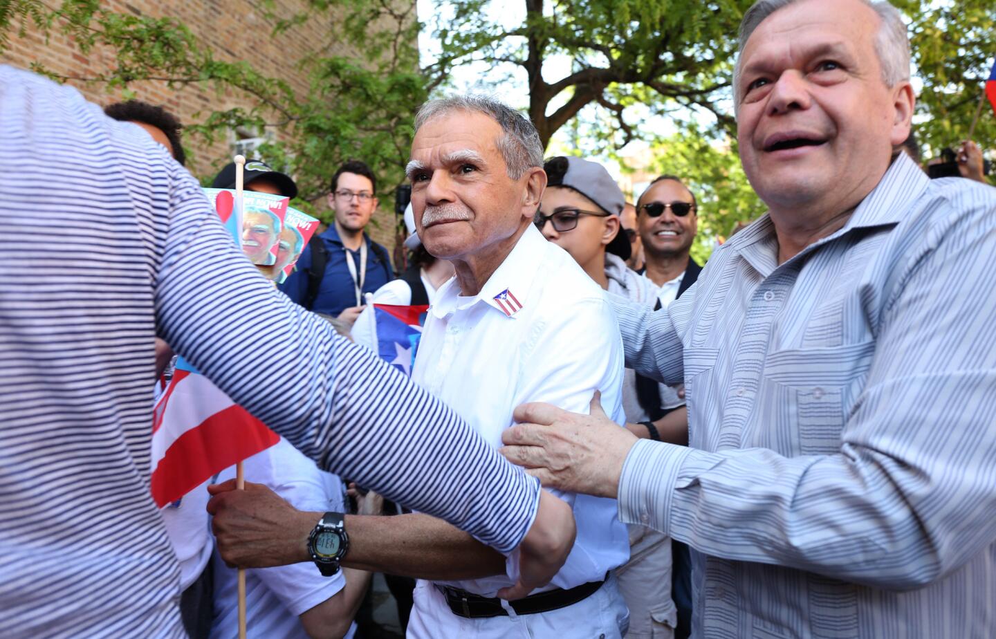 Oscar Lopez Rivera, center, is led by his brother Jose Lopez, right, into La Casita de Don Pedro in his first stop in Humboldt Park on May 18, 2017. President Barack Obama commuted Lopez's 70-year prison term in January, clearing the way for his early release.