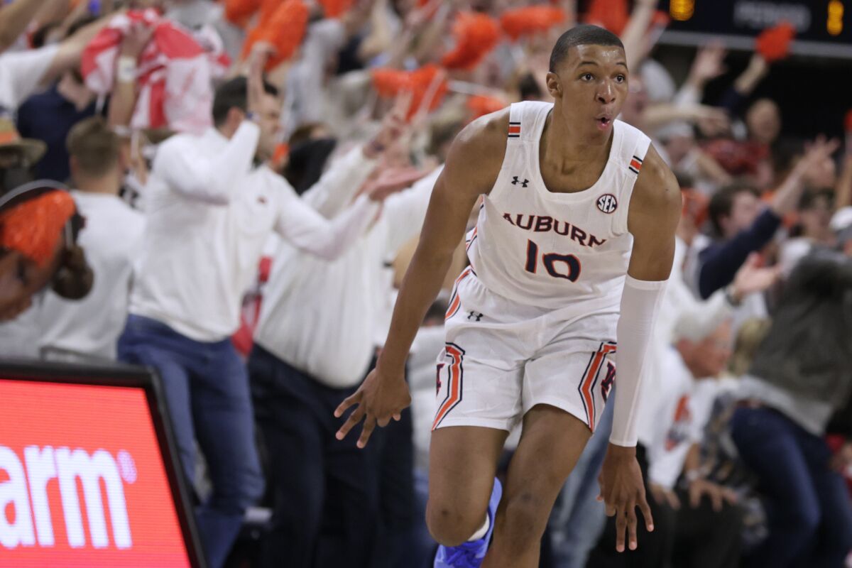 Auburn forward Jabari Smith (10) reacts after making a 3-pointer against Alabama during the first half of an NCAA college basketball game Tuesday, Feb. 1, 2022, in Auburn, Ala. (AP Photo/Butch Dill)