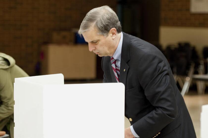 Harrisonburg Sen. Mark Obenshain, Republican candidate for attorney general, marks his ballot in Virgina.