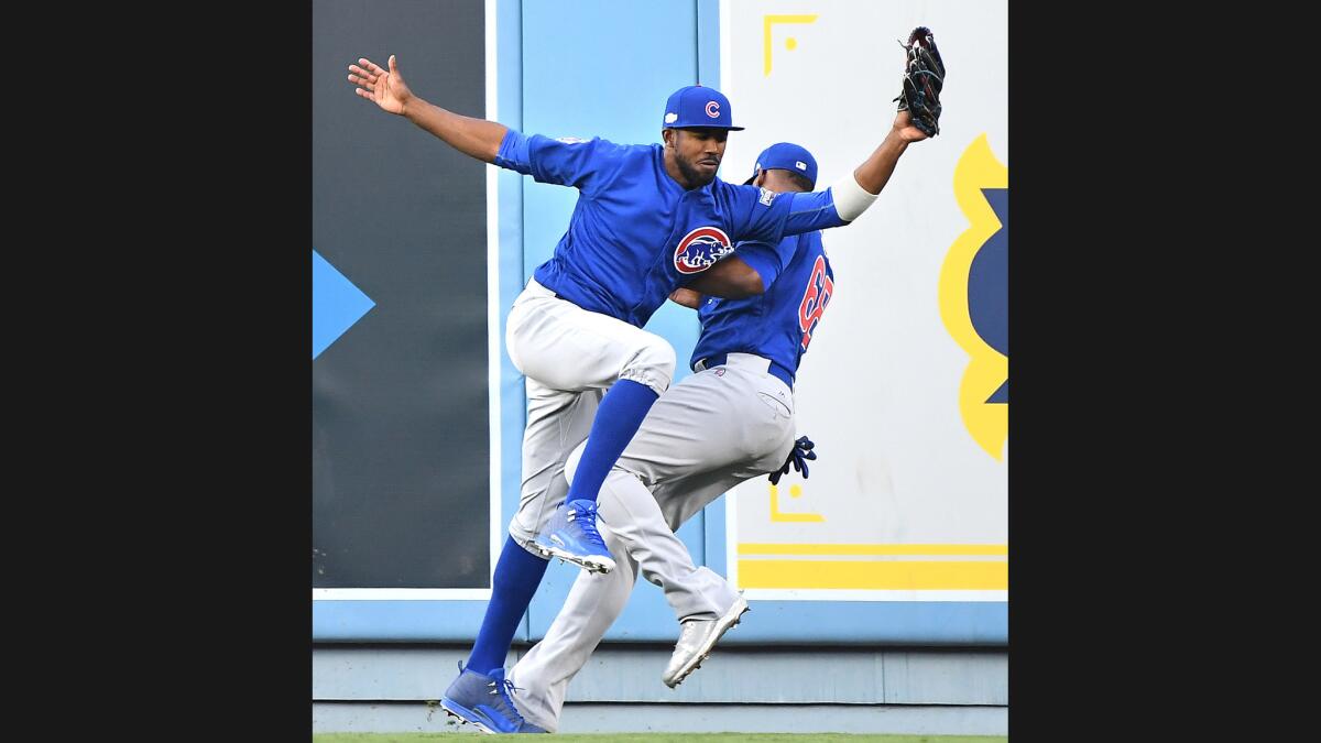 Cubs' Dexter Fowler and Jorge Soler collides on a fly ball hit by Josh Reddick.