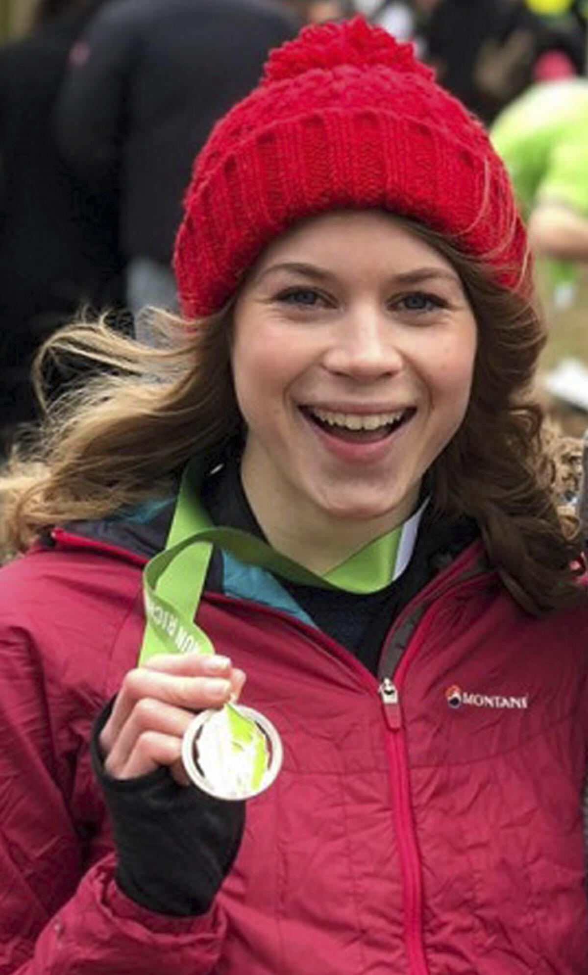 Murder victim Sarah Everard holds a medal hanging from her neck