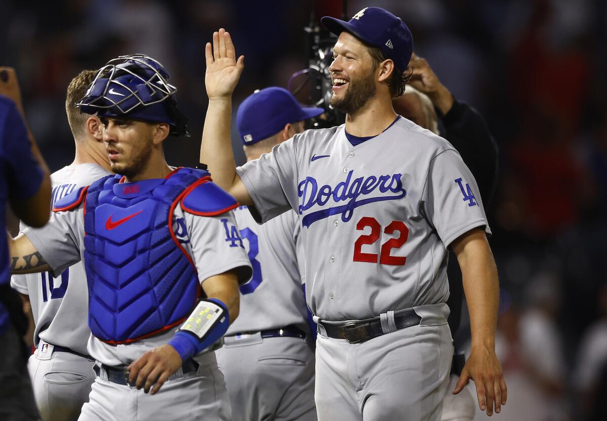 Dodgers pitcher Clayton Kershaw celebrates with teammates after a 9-1 win over the Angels.