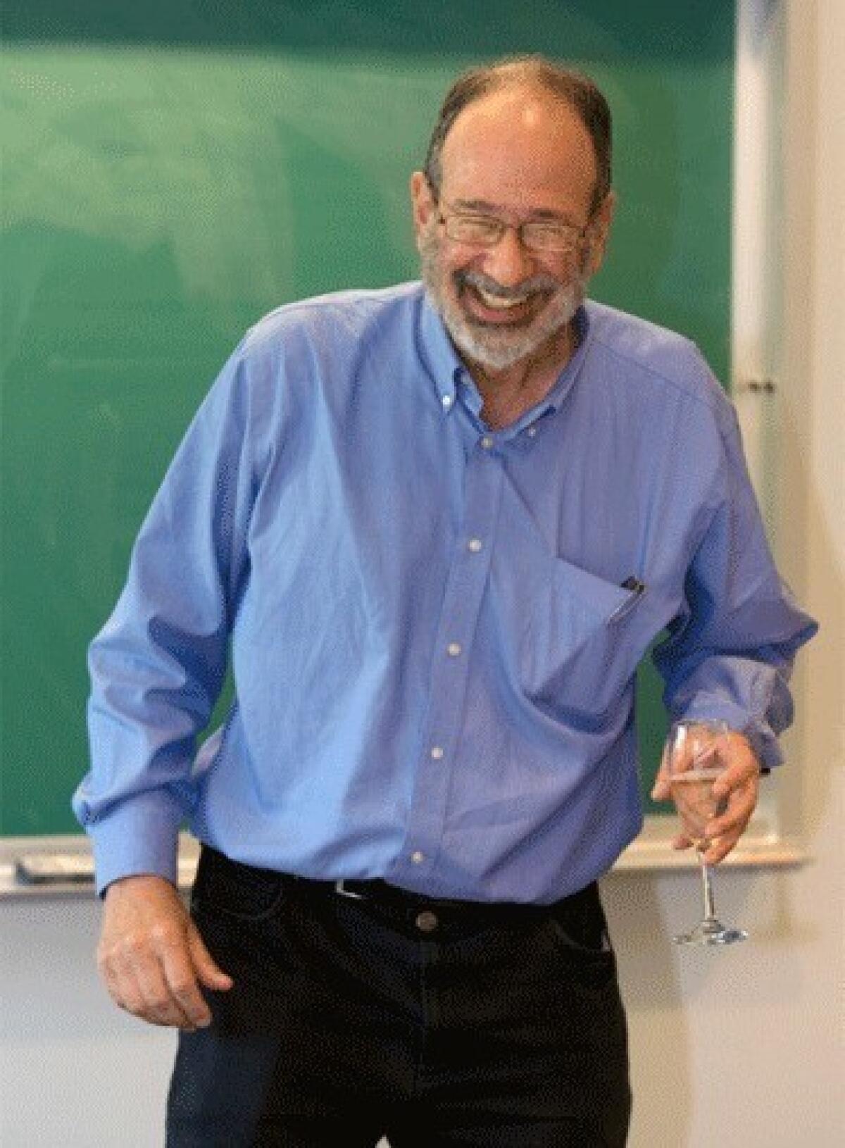 Alvin Roth, a Harvard Business School professor who is currently a visiting professor at Stanford University, reacts during an economics class after receiving a toast from students for being awarded a Nobel Memorial Prize in Economic Sciences.