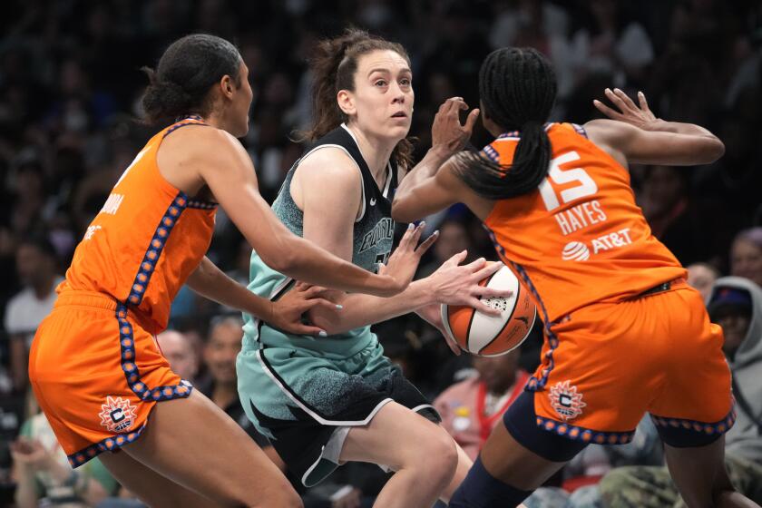 Connecticut Sun guard Tiffany Hayes (15) and forward Olivia Nelson-Ododa (10) guard New York Liberty forward Breanna Stewart, center, during the second half of Game 2 of a WNBA basketball playoffs semifinal Tuesday, Sept. 26, 2023, in New York. (AP Photo/Mary Altaffer)