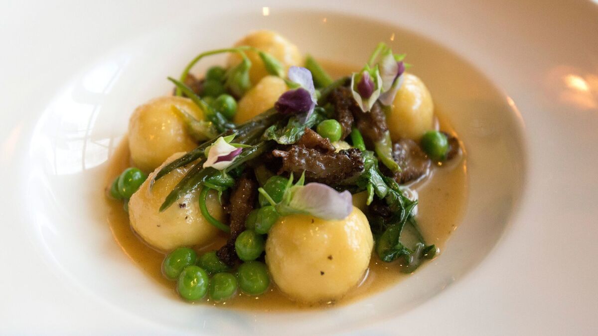 The ricotta gnudi with morels, garlic scapes and English peas at Osteria Mozza. (Myung J. Chun / Los Angeles Times)